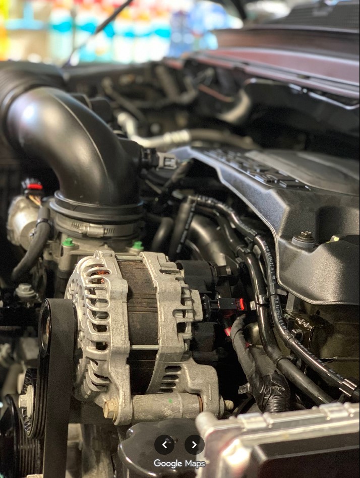 Cleaned engine bay with detailed alternator and hoses