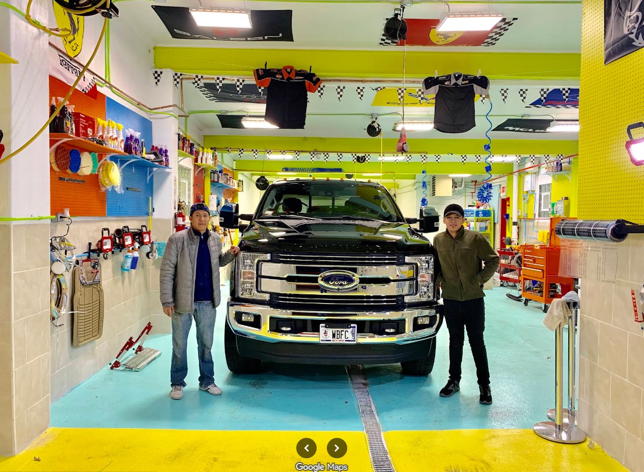 Pro Auto Detail team with a Ford truck inside the detailing bay